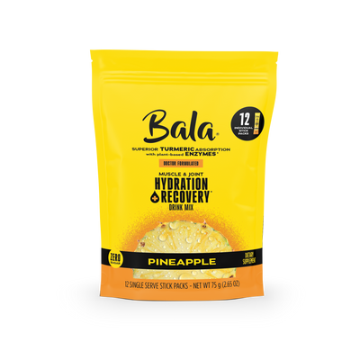 A yellow pouch of Bala Enzyme Bala Total Body Wellness Drink Mix in pineapple flavor, featuring turmeric, enzymes, and plant-based electrolytes, includes 12 single-serve stick packs for rapid hydration and recovery.